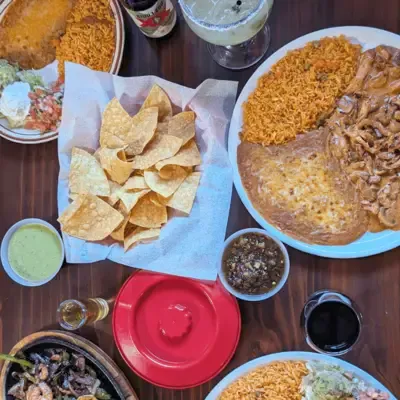 Table spread of chips, salsa, margarita, and combination plates
