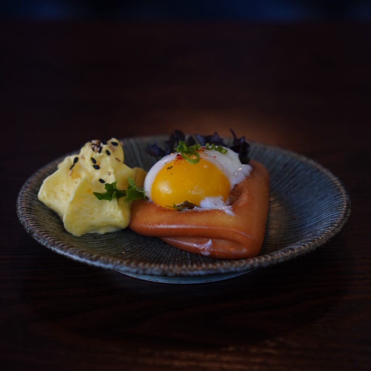 Slow-cooked egg over fried bread with whipped egg, sesame and micro greens