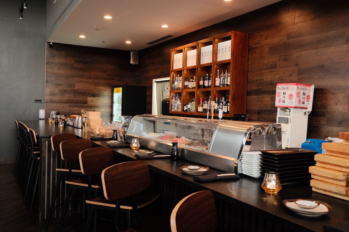 Sushi bar counter with the chef's case and bar stools