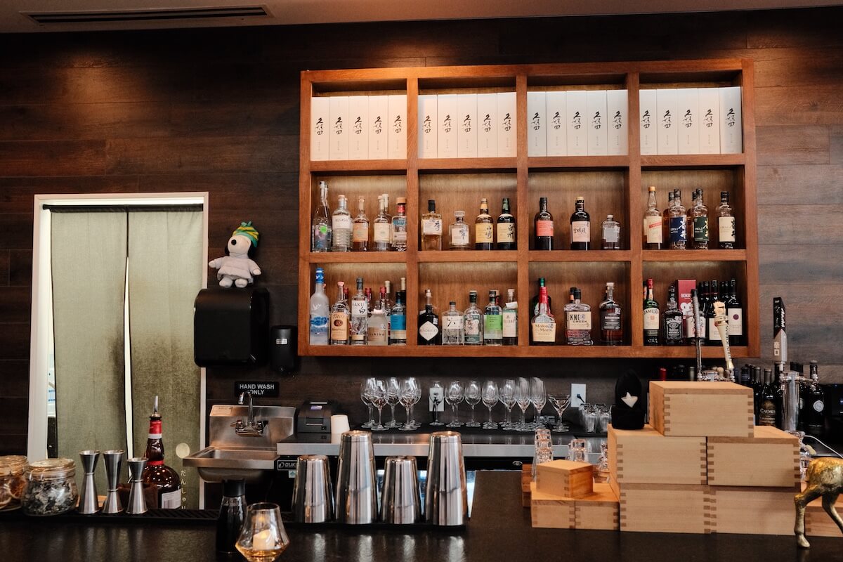 The bar — Japanese whisky and spirits with stacked wooden masu boxes