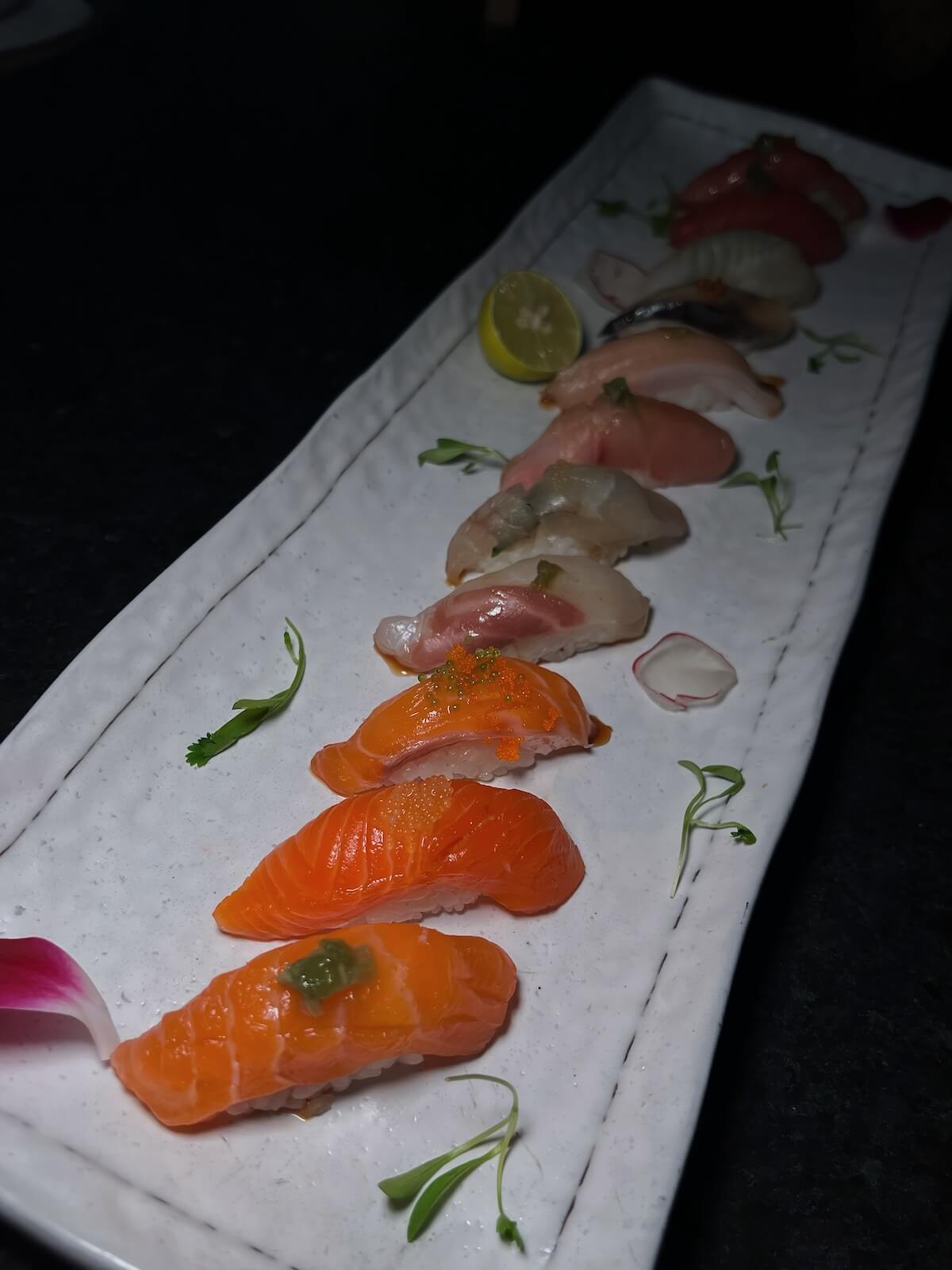 Chef's nigiri tasting — salmon, yellowtail, white fish and tuna on a long plate