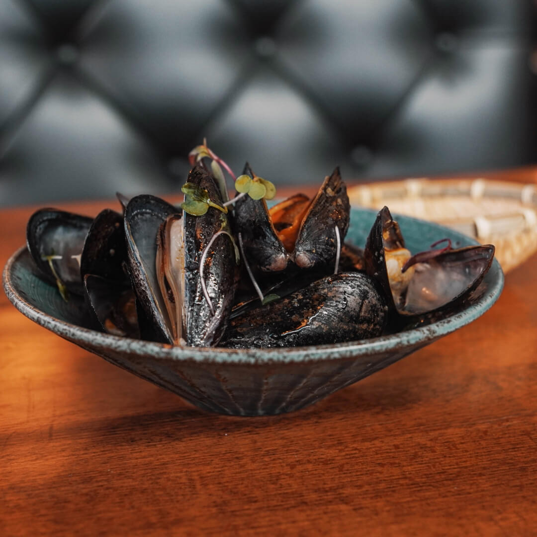 Sake-steamed mussels finished with micro greens
