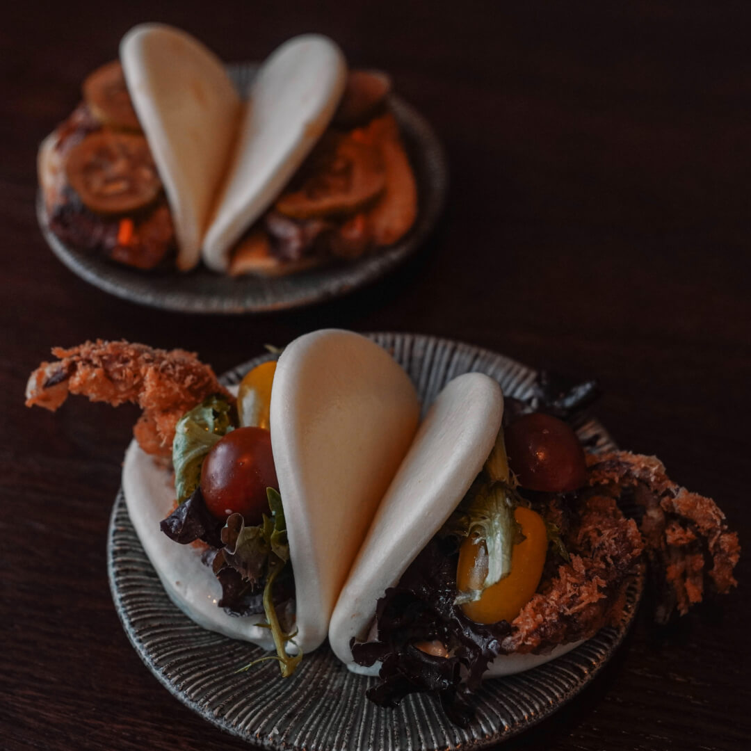 Spider bao with soft-shell crab tempura and chashu bao on ceramic plates