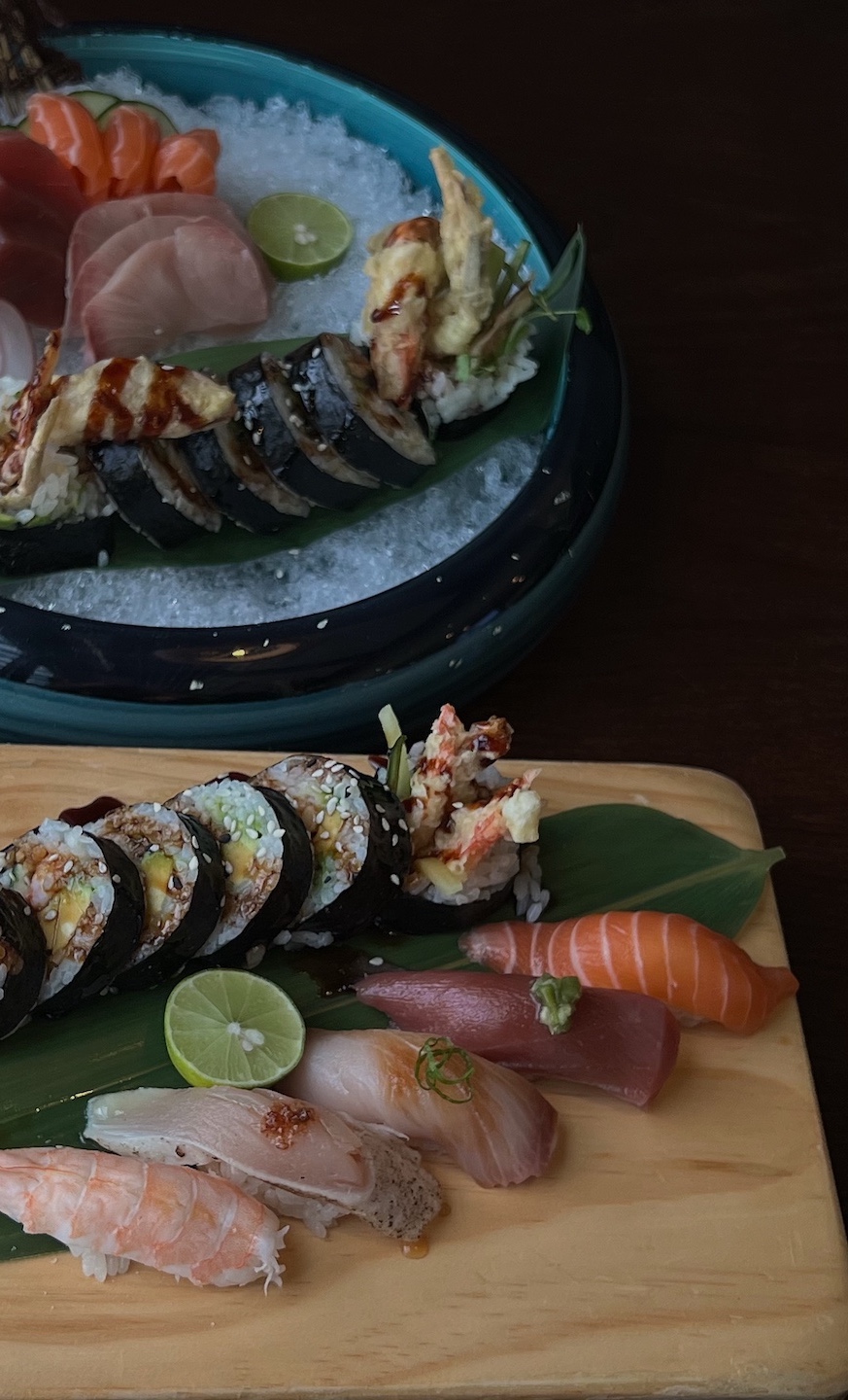 Sushi and sashimi assortment — maki rolls, nigiri and sashimi served on ice