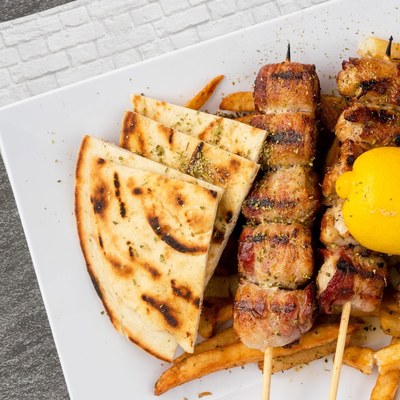 Pork souvlaki with pita and fries