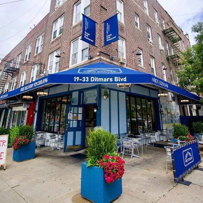 Niko's Souvlaki storefront with its blue awning and sidewalk seating on Ditmars Boulevard in Astoria