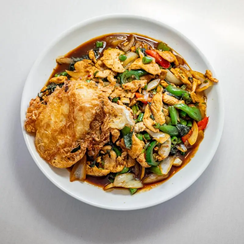 Chicken basil stir-fry with crispy fried egg